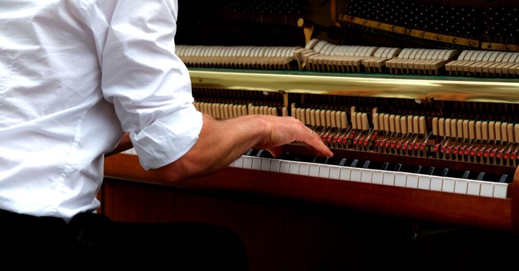 Close-up shot of a musician's hands skillfully playing an upright piano.